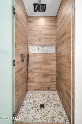 a view of walk in closet with clothes