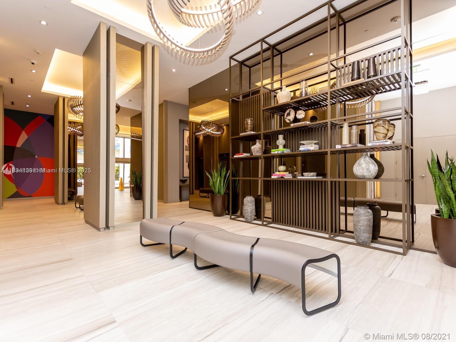 4010 South Ocean Drive, Unit R401 Hollywood, FL 33019 - Photo 2 of 20 a living room with walk in closet and rug