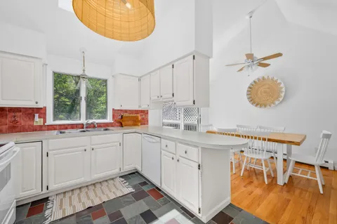 a kitchen with a sink cabinets and window