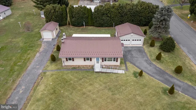 a view of a house with a yard and sitting area