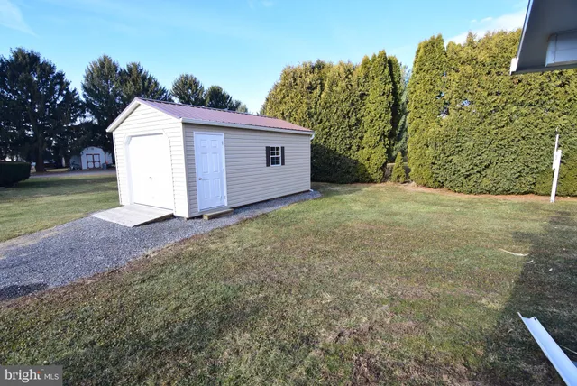 a view of a house with a yard and garage