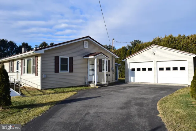 a view of a house with a house in the background