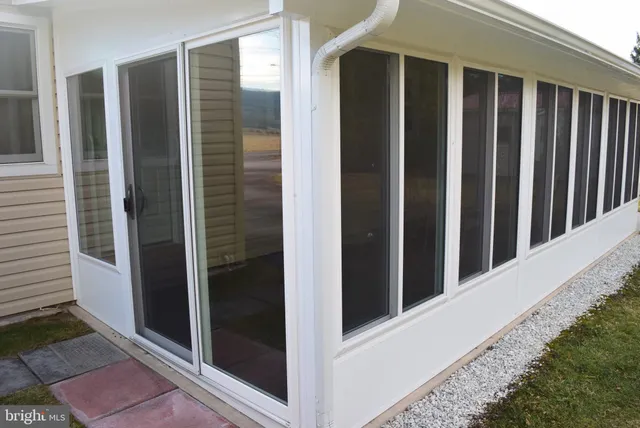 a view of a house with backyard and porch