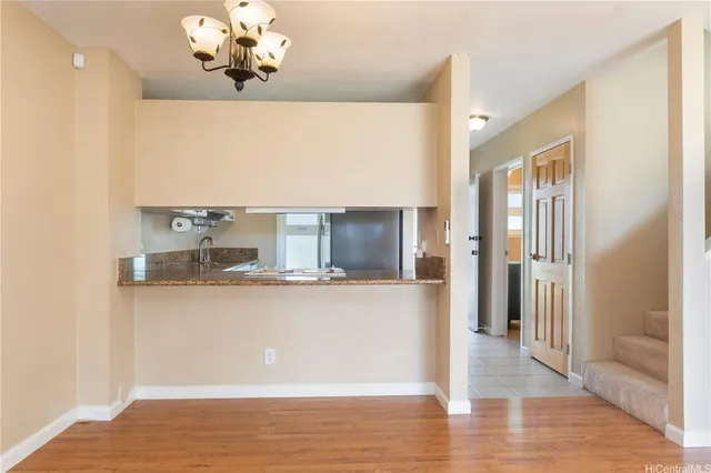 a view of a kitchen with wooden floor and a kitchen
