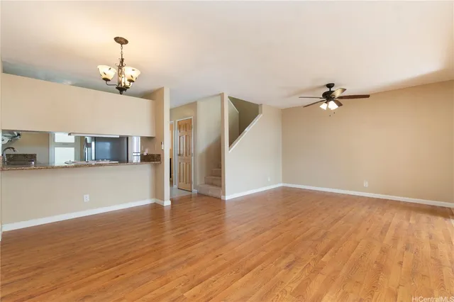 a view of a room with wooden floor closet and a window