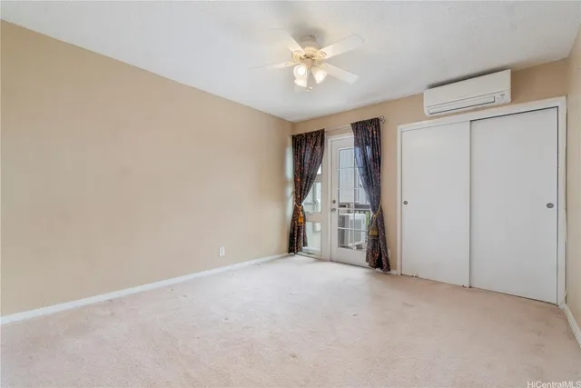 a view of empty room with ceiling fan