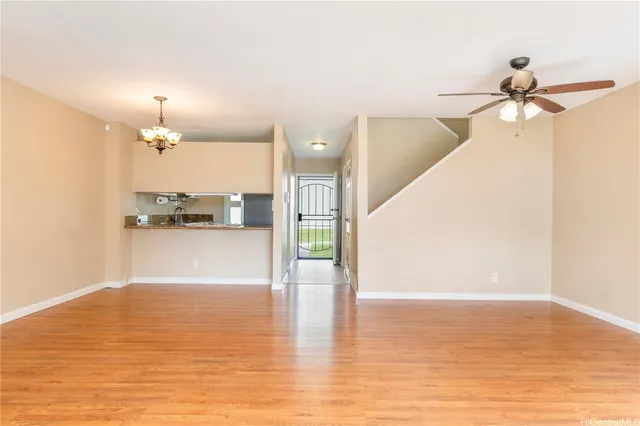 a view of a kitchen with wooden floor and a ceiling fan