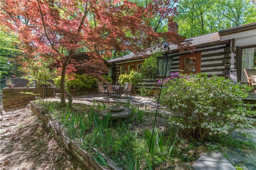 571 Wilderness Road Tryon, NC 28782 - Photo 8 of 41 a backyard of a house with lots of green space and fountain