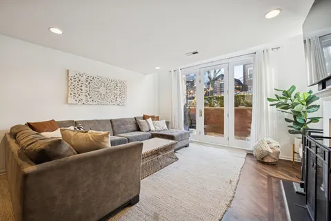 a living room with furniture and large windows