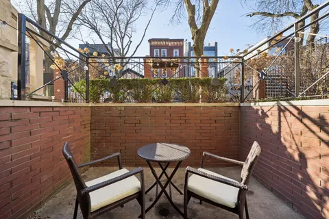 a view of a chairs and table in the balcony