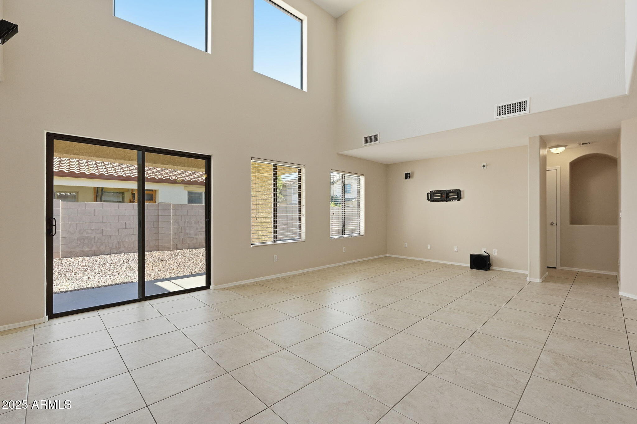 2691 South Chaparral Road Apache Junction, AZ 85119 - Photo 11 of 43 a view of an empty room with window and chandelier