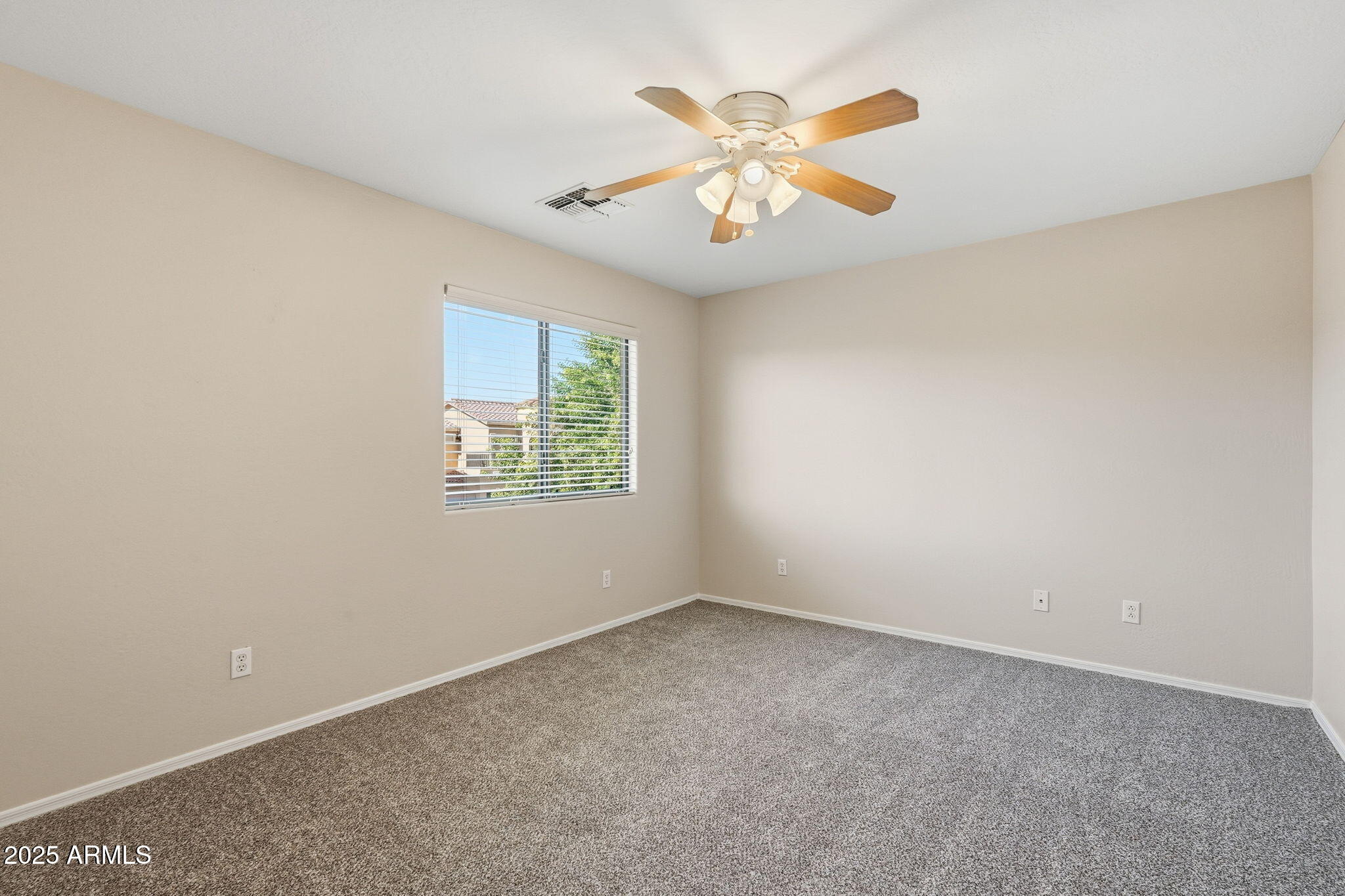 2691 South Chaparral Road Apache Junction, AZ 85119 - Photo 19 of 43 an empty room with windows and fan