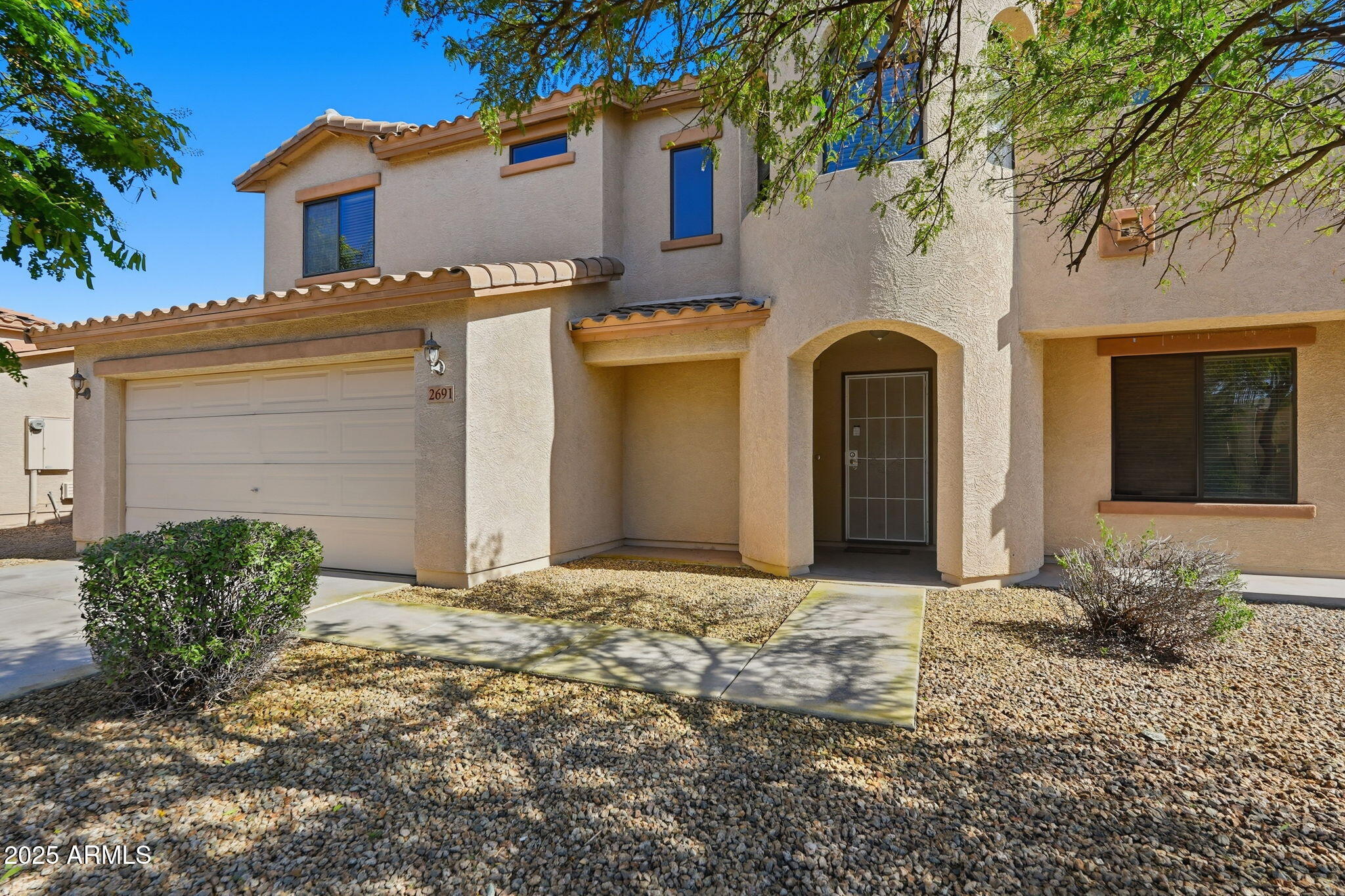 2691 South Chaparral Road Apache Junction, AZ 85119 - Photo 5 of 43 a front view of a house with a yard