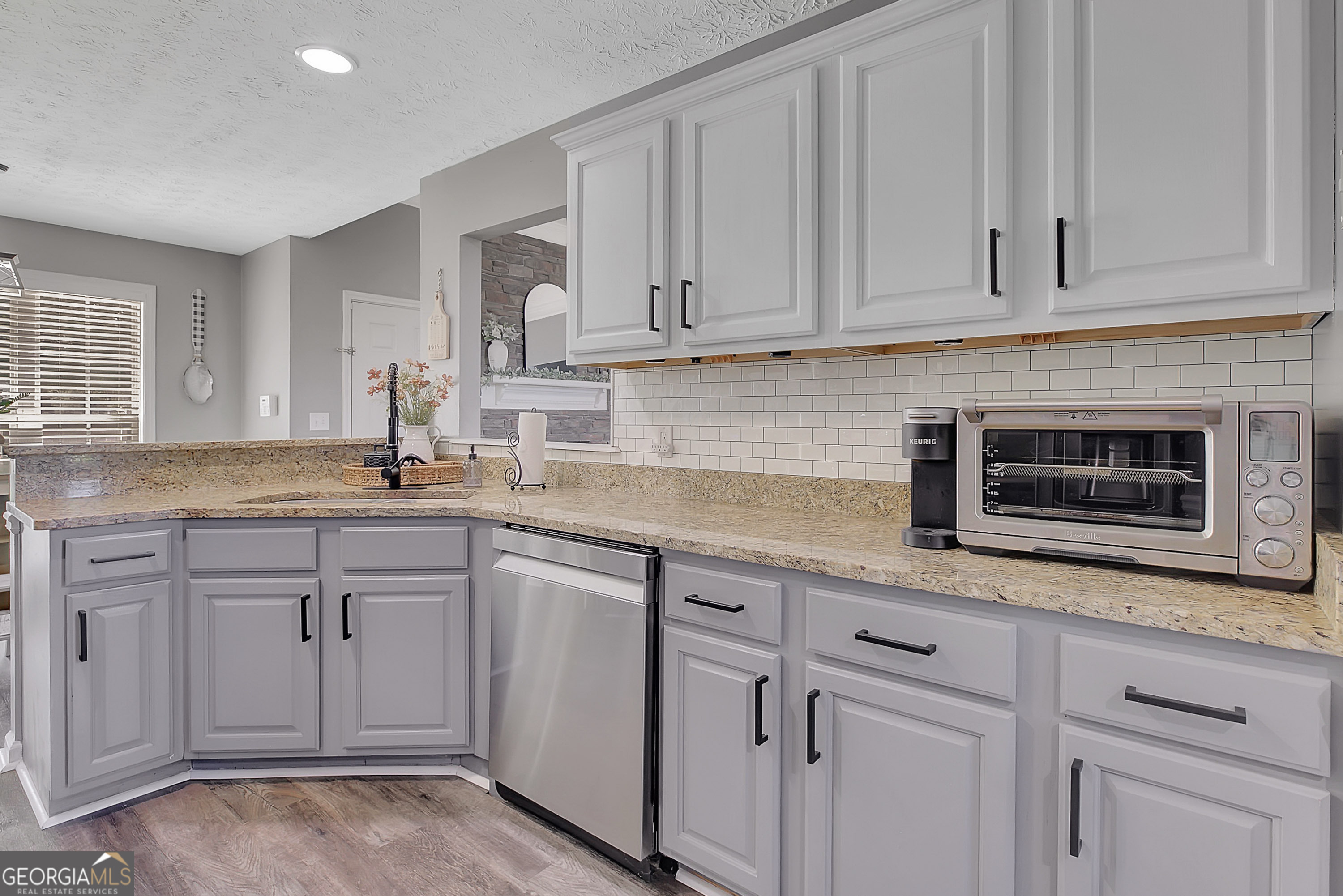 229 John Lovelace Road LaGrange, GA 30241 - Photo 28 of 59 a kitchen with white cabinets and sink