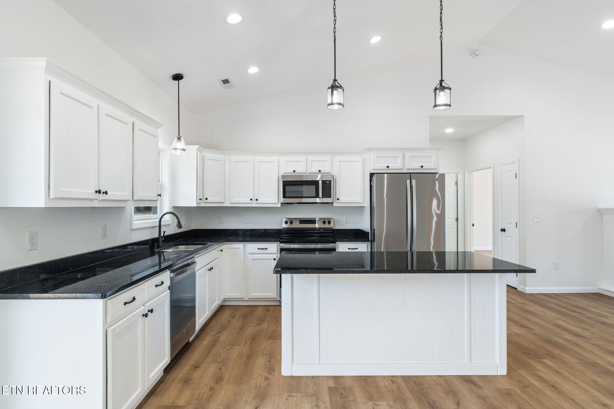 680 Kaylee Lane Del Rio, TN 37727 - Photo 12 of 41 a large kitchen with stainless steel appliances granite countertop a stove a sink and a refrigerator