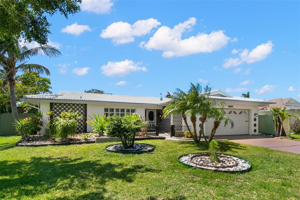 a swimming pool with barbeque oven and potted plants