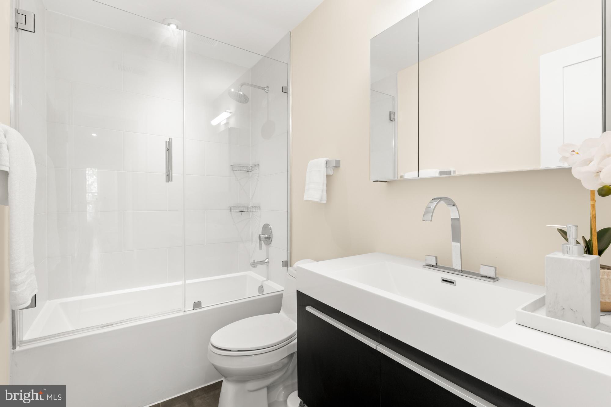 16 Grant Circle Northwest, Unit 2 Washington, DC 20011 - Photo 15 of 35 a bathroom with a sink a toilet and a bathtub