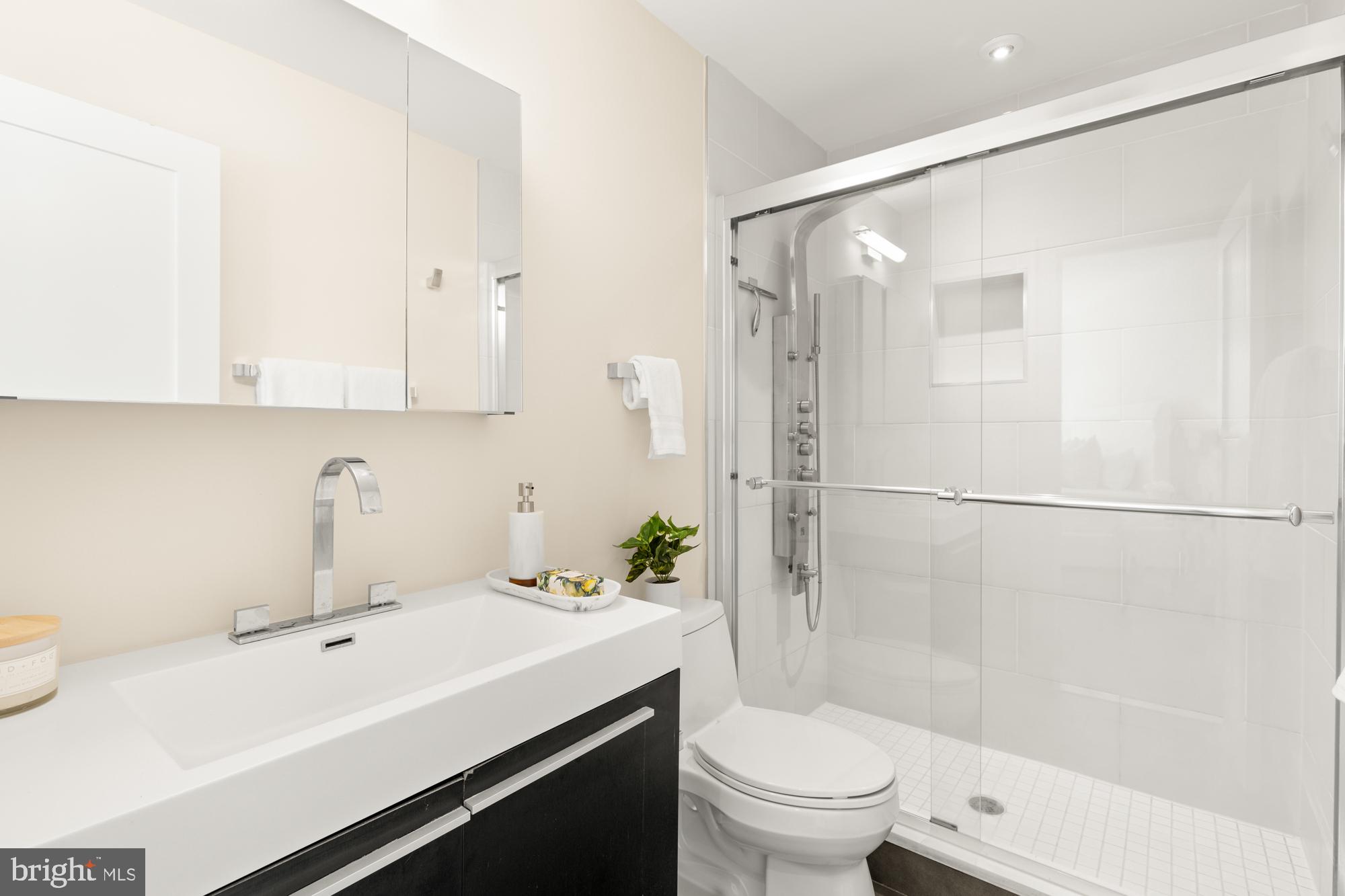 16 Grant Circle Northwest, Unit 2 Washington, DC 20011 - Photo 19 of 35 a bathroom with a sink a toilet and shower