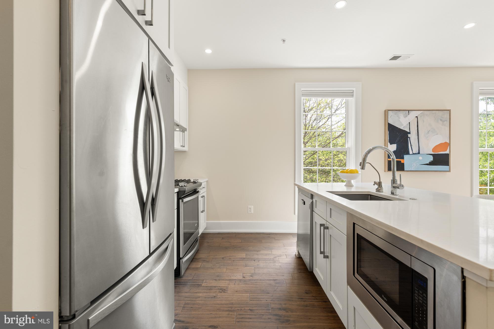 16 Grant Circle Northwest, Unit 2 Washington, DC 20011 - Photo 6 of 35 a kitchen with stainless steel appliances granite countertop a refrigerator and a sink