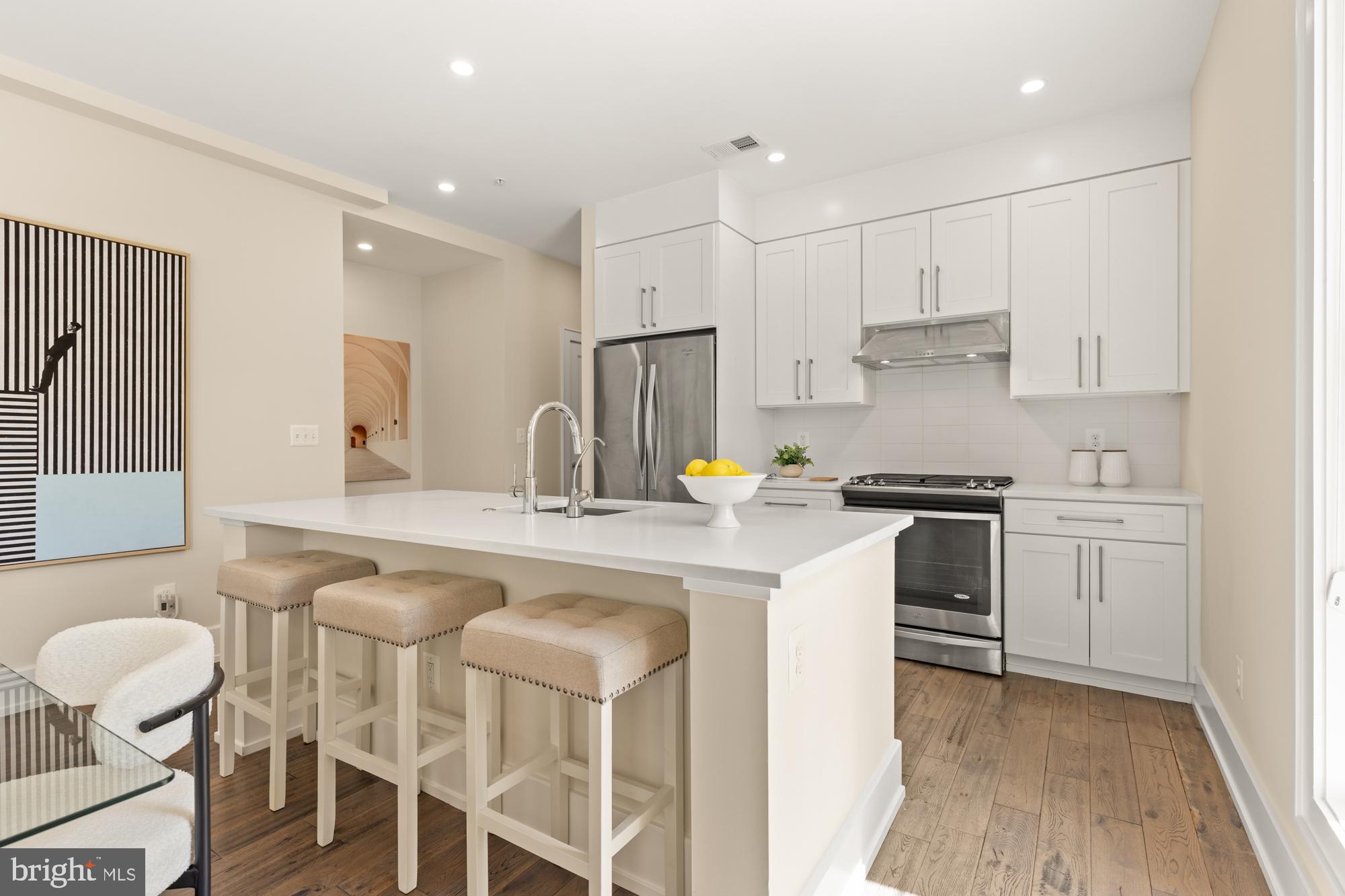 16 Grant Circle Northwest, Unit 2 Washington, DC 20011 - Photo 9 of 35 a kitchen with a sink stove and white cabinets
