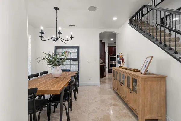 a kitchen with stainless steel appliances granite countertop a stove top oven a sink and a refrigerator