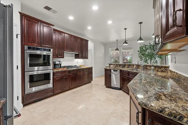 a kitchen with a sink stove and refrigerator