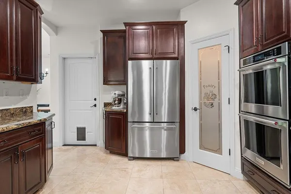 a kitchen with stainless steel appliances granite countertop stove a sink and a refrigerator