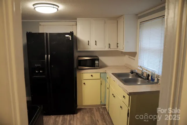 a kitchen with a refrigerator and a stove