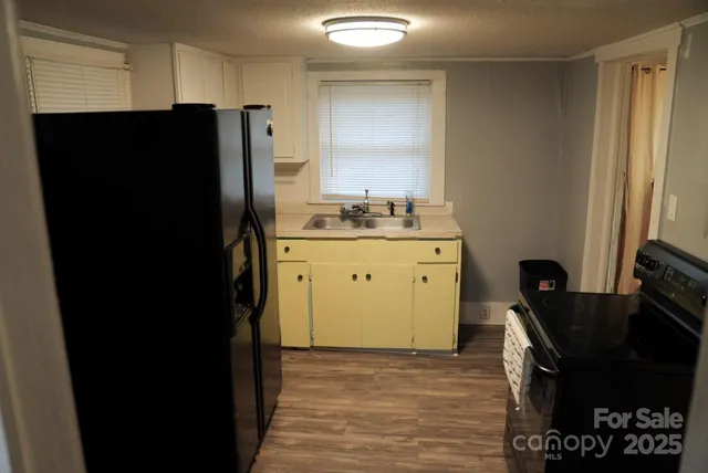 a kitchen with a refrigerator and a stove