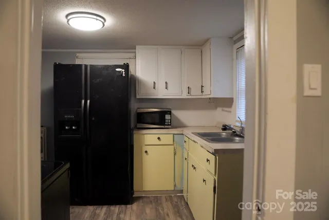 a kitchen with a refrigerator and a stove