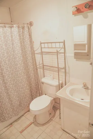 a white toilet sitting next to a bathroom sink