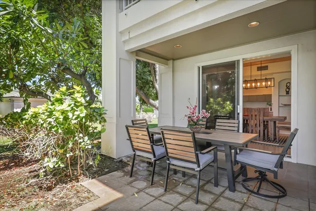 a view of a patio with table and chairs and potted plants