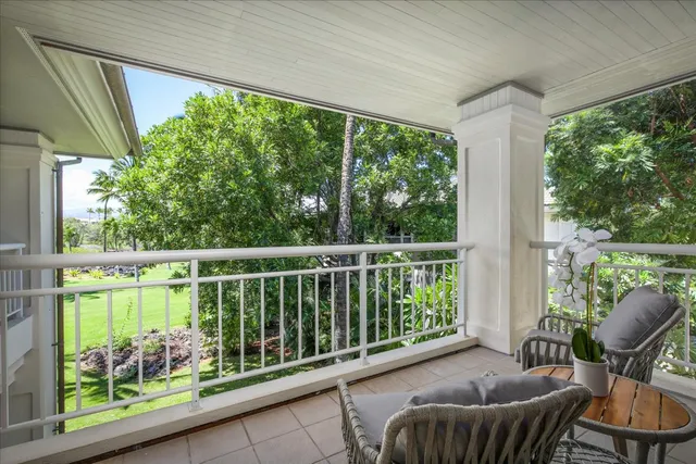 a balcony with furniture and a potted plant