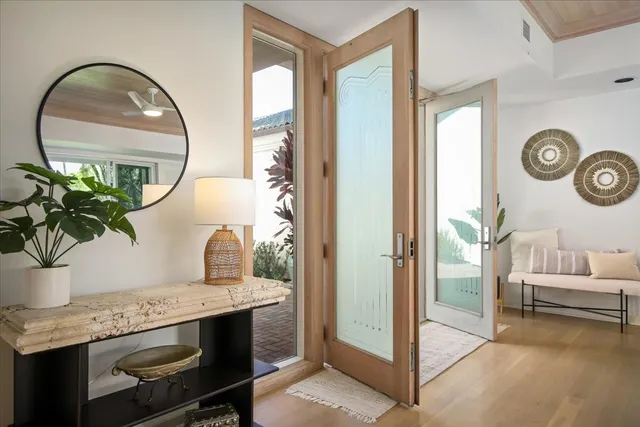 a living room with furniture and a mirror