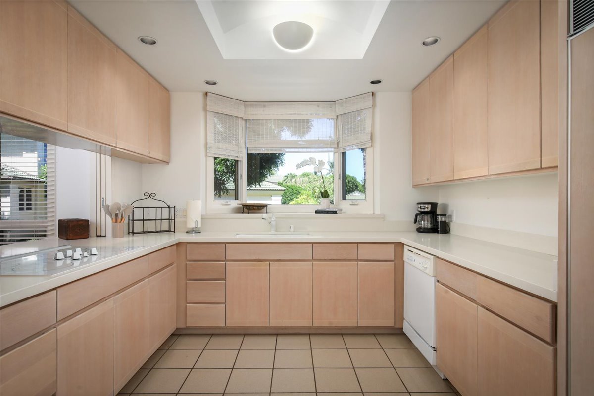 68-1375 Pauoa Road, Unit D4 Kamuela, HI 96743 - Photo 7 of 30 a kitchen with a sink dishwasher a stove and white cabinets