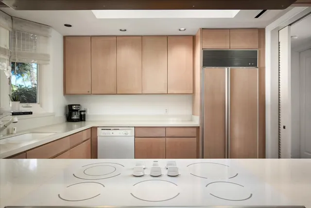 a kitchen with a refrigerator and a sink
