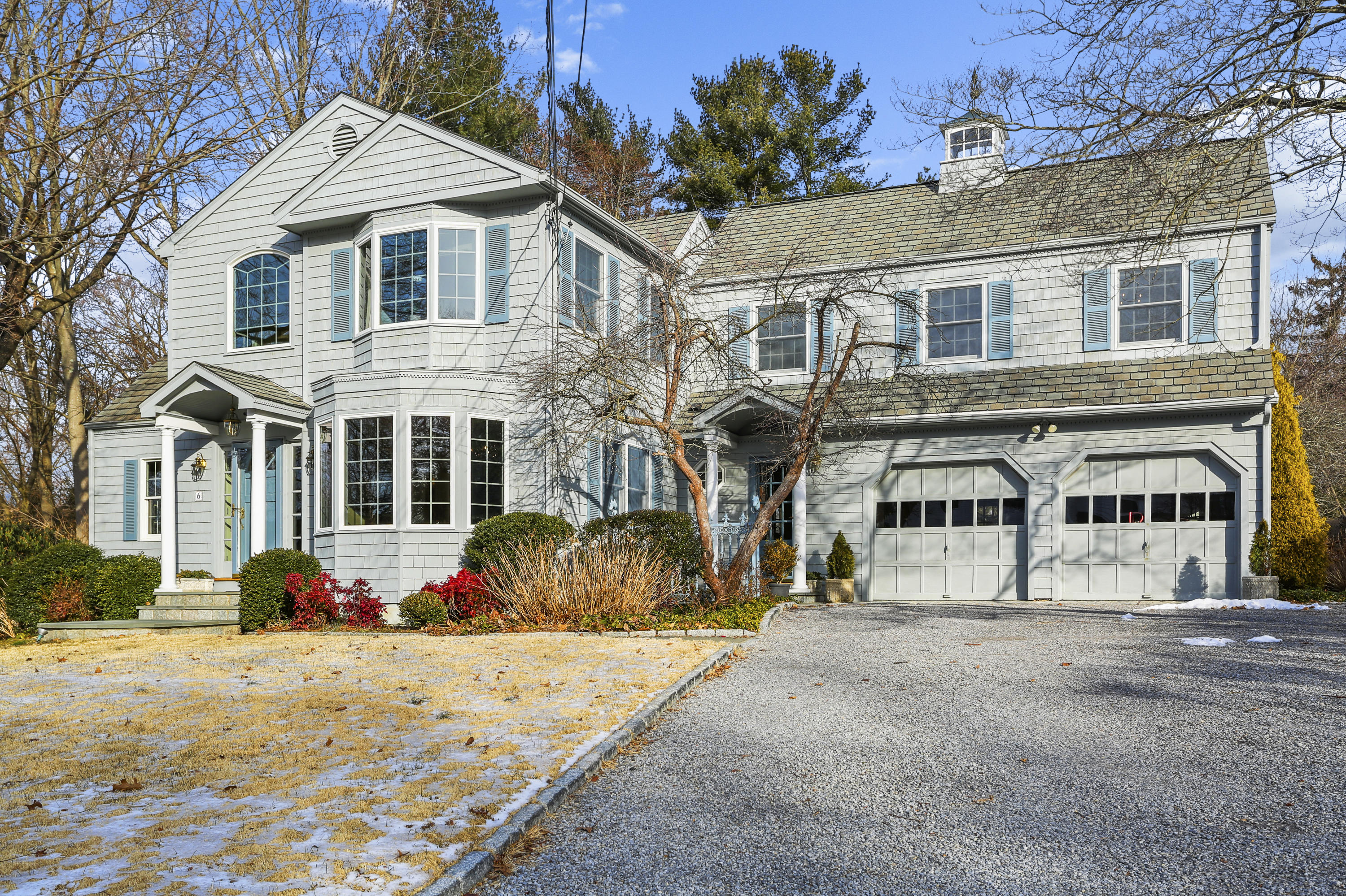 6 Echo Drive Darien, CT 06820 - Photo 2 of 37 a front view of a building with many windows