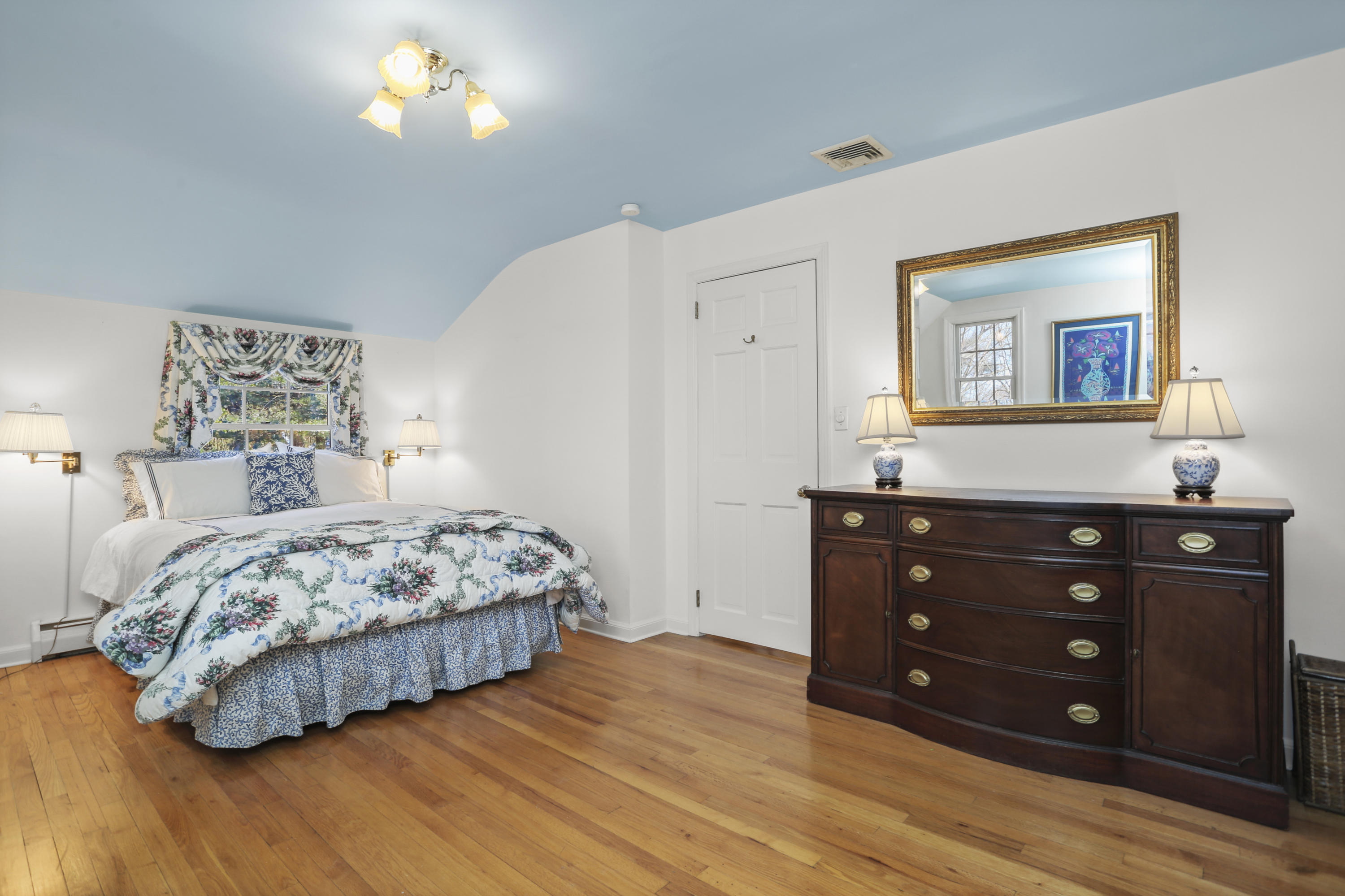 6 Echo Drive Darien, CT 06820 - Photo 21 of 37 a bedroom with a bed and a lamp on dresser