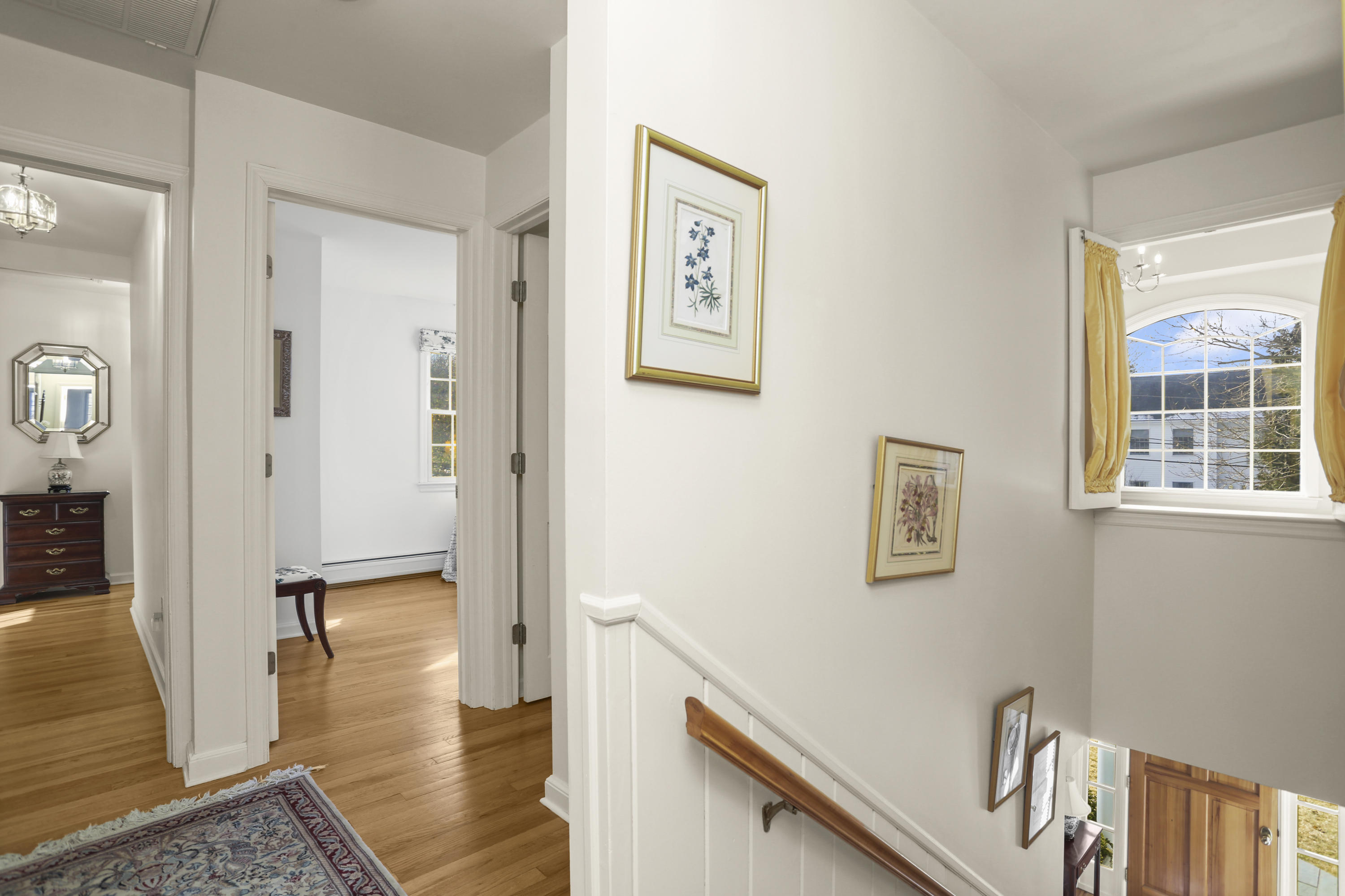 6 Echo Drive Darien, CT 06820 - Photo 23 of 37 a view of a hallway with wooden floor and dining room
