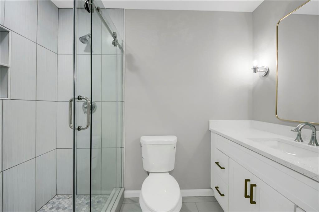 24 Echo Ridge Drive Powder Springs, GA 30127 - Photo 12 of 28 a bathroom with a toilet sink and shower