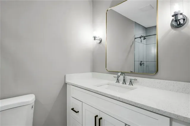 a bathroom with a sink toilet and vanity