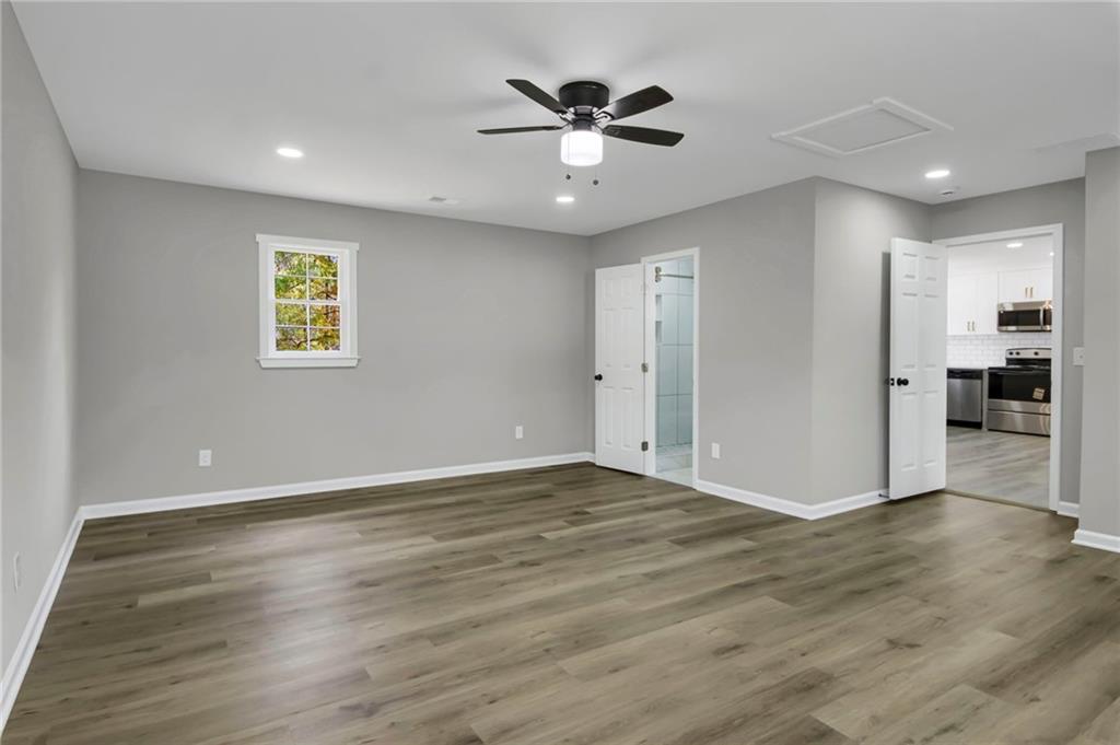 24 Echo Ridge Drive Powder Springs, GA 30127 - Photo 22 of 28 a view of an empty room with wooden floor and a ceiling fan