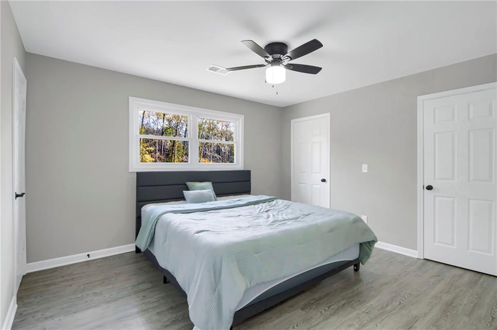 24 Echo Ridge Drive Powder Springs, GA 30127 - Photo 23 of 28 a bedroom with a bed and a chandelier