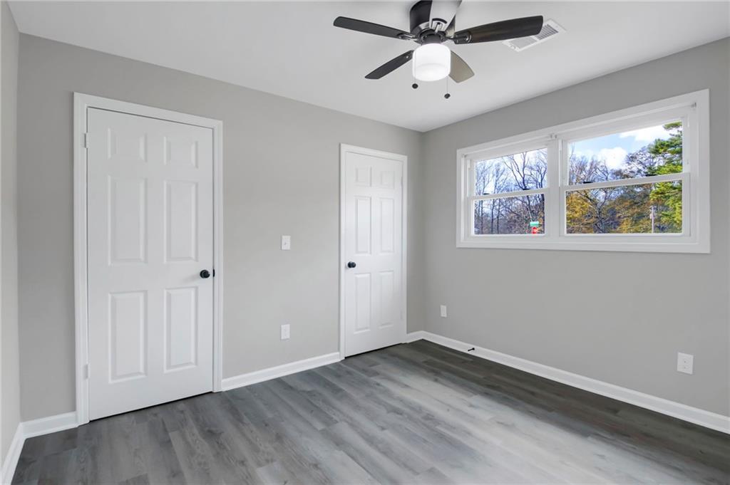 24 Echo Ridge Drive Powder Springs, GA 30127 - Photo 25 of 28 a view of an empty room with wooden floor and a window
