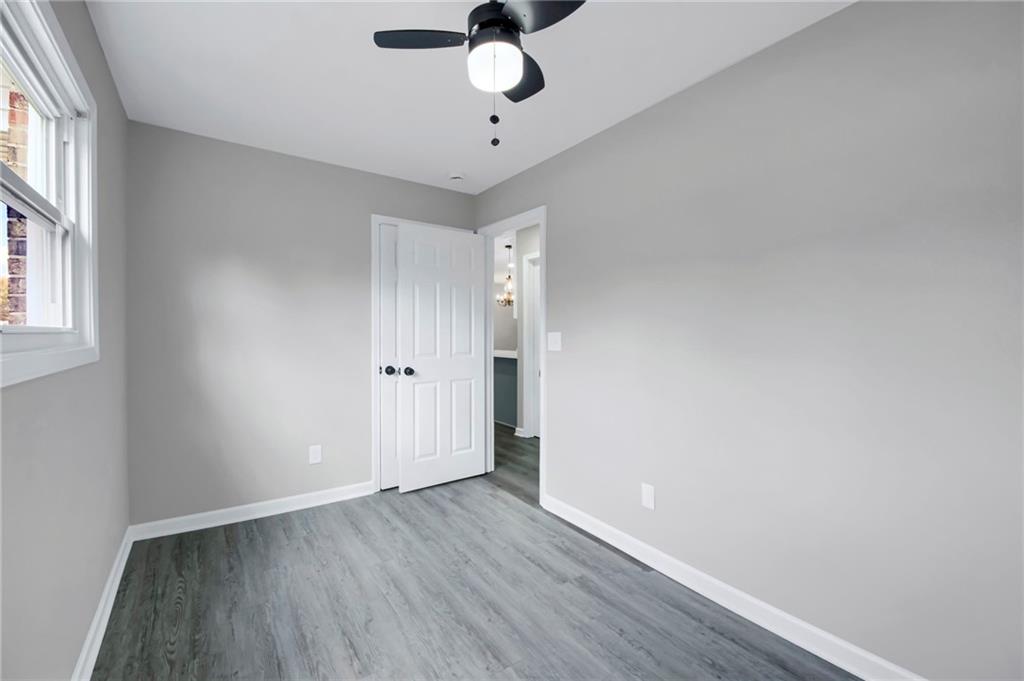 24 Echo Ridge Drive Powder Springs, GA 30127 - Photo 26 of 28 a view of an empty room with window and wooden floor