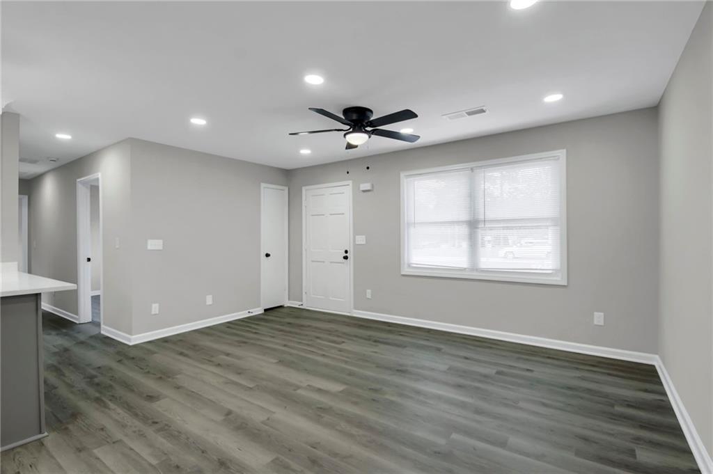 24 Echo Ridge Drive Powder Springs, GA 30127 - Photo 6 of 28 an empty room with wooden floor and windows