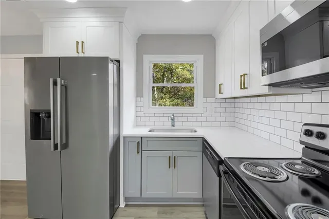 a kitchen with a stove and a refrigerator