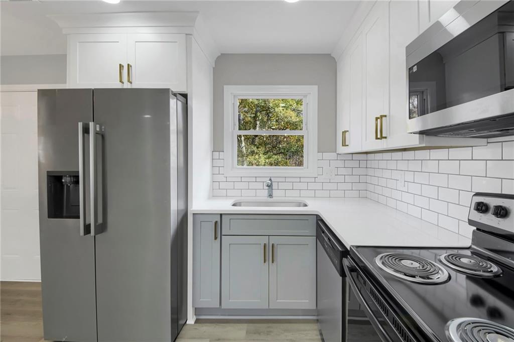 24 Echo Ridge Drive Powder Springs, GA 30127 - Photo 10 of 28 a kitchen with a stove and a refrigerator