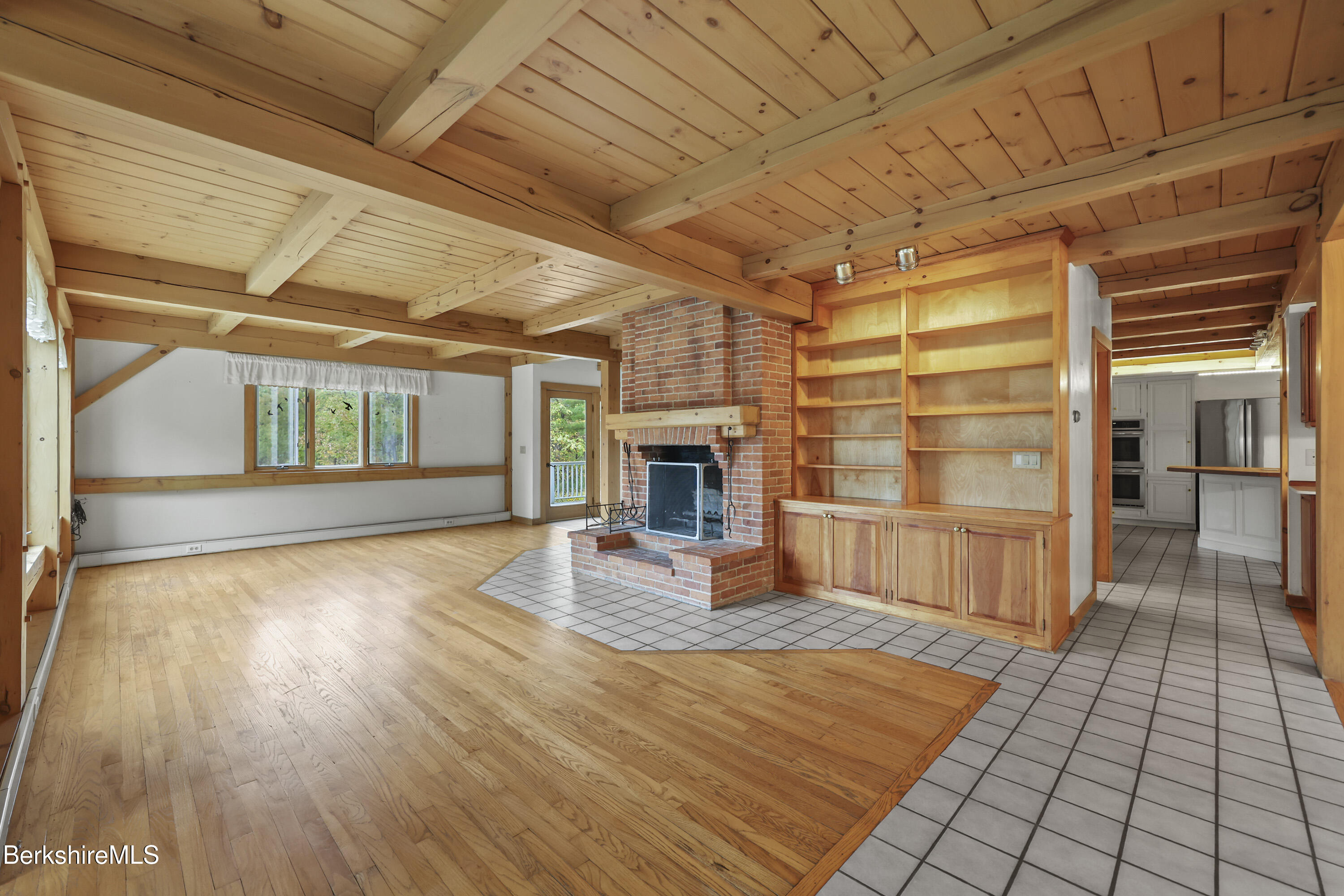 1030 Simonds Road Williamstown, MA 01267 - Photo 8 of 76 a view of empty room with wooden floor and fireplace