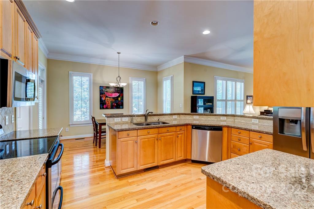 1944 Clark Elliot Street Fort Mill, SC 29708 - Photo 11 of 46 a large white kitchen with wooden floor and a sink